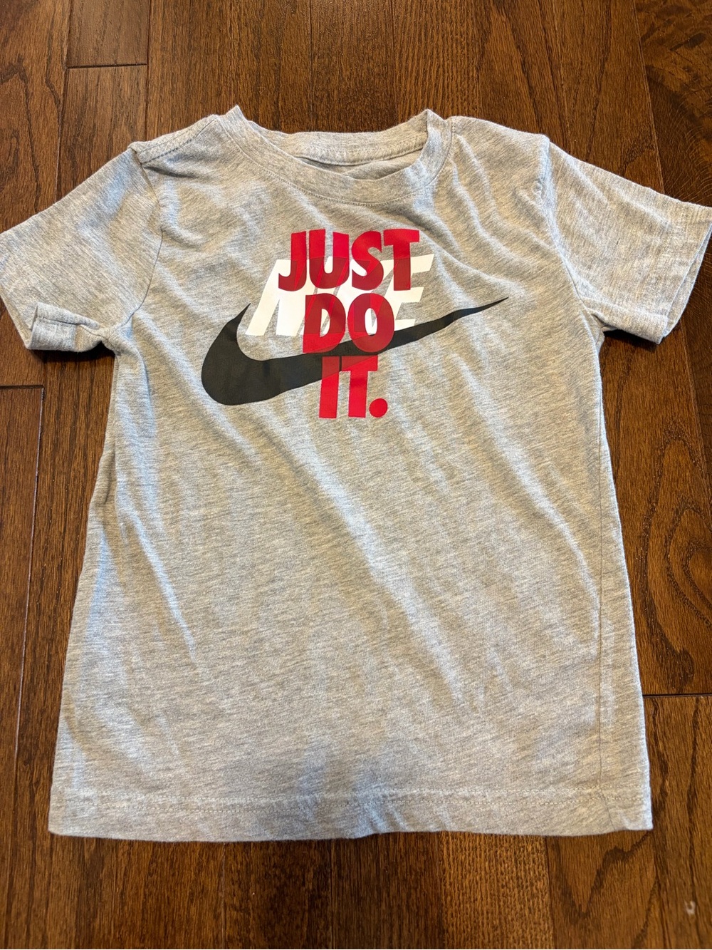 Nike Gray Kids Short Sleeve Tee with Black Swoosh and Red 'Just Do It'